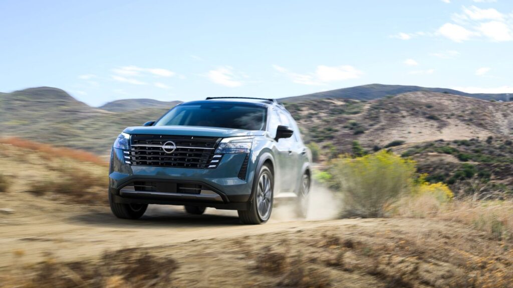 2026 Nissan Pathfinder driving on a dirt road showing rugged capability
