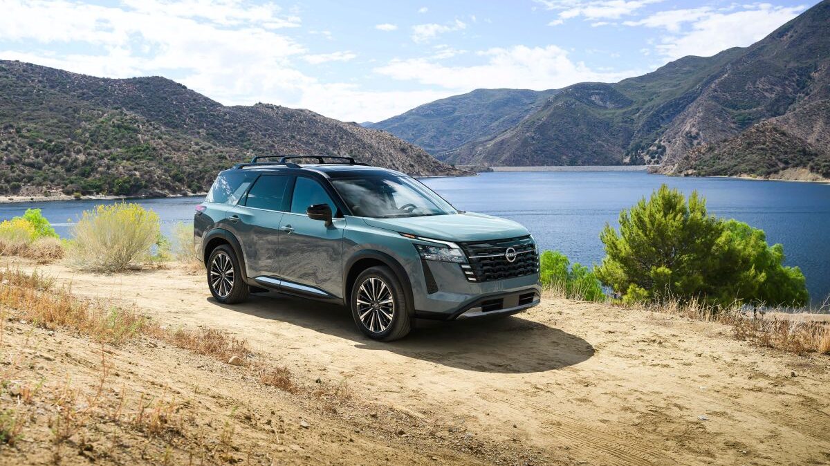 2026 Nissan Pathfinder parked outdoors with lake and mountain backdrop